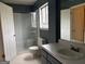 This bathroom offers a glass enclosed shower, sink and toilet at 5793 Springfield Pl, Ellenwood, GA 30294