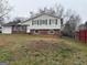 Inviting two-story home with brick accents, a front yard and budding trees at 5793 Springfield Pl, Ellenwood, GA 30294