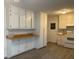 Bright kitchen featuring white cabinets, wood-look countertops, and hard-surface flooring at 5793 Springfield Pl, Ellenwood, GA 30294