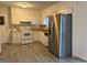 Functional kitchen with white cabinets, wood-look countertops, and stainless steel refrigerator at 5793 Springfield Pl, Ellenwood, GA 30294