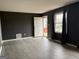 Bright living room featuring a white door, gray walls and hard-surface floors at 5793 Springfield Pl, Ellenwood, GA 30294