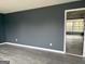 Spacious living room with dark gray walls and light gray wood-look flooring at 5793 Springfield Pl, Ellenwood, GA 30294