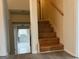 Wooden staircase with white trim and a view into the lower level at 5793 Springfield Pl, Ellenwood, GA 30294
