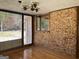 Living room featuring a brick wall, large windows, and a vintage chandelier at 6099 Winview Dr, Forest Park, GA 30297