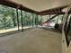 Covered back patio overlooking a wooded backyard at 370 Rosetta Nw Ln, Conyers, GA 30012
