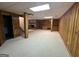 Spacious basement featuring paneled walls, carpet, and stone fireplace at 370 Rosetta Nw Ln, Conyers, GA 30012