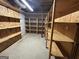 Unfinished basement with ample wooden shelving for storage at 370 Rosetta Nw Ln, Conyers, GA 30012