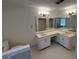 Well-lit bathroom featuring double sinks with vanity and ample counter space at 370 Rosetta Nw Ln, Conyers, GA 30012