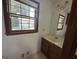 Bathroom vanity with neutral color cabinets, a large window, and modern fixtures at 370 Rosetta Nw Ln, Conyers, GA 30012
