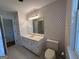 Bright bathroom with a toilet, vanity, mirror, and shower/tub at 370 Rosetta Nw Ln, Conyers, GA 30012