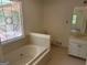 Bright bathroom features a garden tub under a stained glass window and a vanity at 370 Rosetta Nw Ln, Conyers, GA 30012