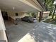 Attached carport featuring a bench, concrete flooring, and easy access to the house and backyard at 370 Rosetta Nw Ln, Conyers, GA 30012
