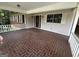 Expansive covered porch with a brick floor, offering ample space for relaxing and enjoying the outdoor views at 370 Rosetta Nw Ln, Conyers, GA 30012