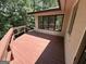 Red painted wooden deck provides great views of the surrounding lush green trees at 370 Rosetta Nw Ln, Conyers, GA 30012