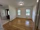 Dining room boasts hardwood floors, white walls with wood trim, and natural light from two windows at 370 Rosetta Nw Ln, Conyers, GA 30012