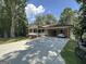 Cozy single-story home with a covered carport and a charming porch, surrounded by mature trees at 370 Rosetta Nw Ln, Conyers, GA 30012