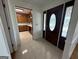 Tiled foyer with an oval glass front door leading to a kitchen with wood cabinets at 370 Rosetta Nw Ln, Conyers, GA 30012
