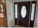 Inviting front entrance with a dark wood door featuring decorative oval glass and side panels at 370 Rosetta Nw Ln, Conyers, GA 30012
