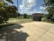 View from garage pad overlooking yard and pond on a sunny day at 370 Rosetta Nw Ln, Conyers, GA 30012
