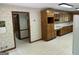 Spacious kitchen featuring wood cabinets, white refrigerator and patterned wallpaper at 370 Rosetta Nw Ln, Conyers, GA 30012
