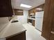 Functional kitchen with white appliances and wood cabinets at 370 Rosetta Nw Ln, Conyers, GA 30012
