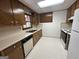 Bright kitchen with white countertops, wood cabinetry, and a window above the sink at 370 Rosetta Nw Ln, Conyers, GA 30012