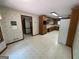 Spacious kitchen featuring wood cabinets, white refrigerator and patterned wallpaper at 370 Rosetta Nw Ln, Conyers, GA 30012