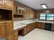 Spacious kitchen featuring wood cabinets, black appliances and plenty of countertop space at 370 Rosetta Nw Ln, Conyers, GA 30012