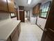 Clean laundry room with washer, dryer, and ample wooden cabinet storage for organization at 370 Rosetta Nw Ln, Conyers, GA 30012