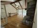 Open living room featuring hardwood floors, exposed beams, stone fireplace, and large doors at 370 Rosetta Nw Ln, Conyers, GA 30012