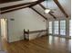 Bright living room with hardwood floors, vaulted ceilings, and doors opening to a sunroom at 370 Rosetta Nw Ln, Conyers, GA 30012