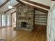 Spacious living room with hardwood floors, a stone fireplace, and built-in shelving at 370 Rosetta Nw Ln, Conyers, GA 30012