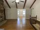 Open living room features hardwood floors, stone fireplace, and staircase with wood railings at 370 Rosetta Nw Ln, Conyers, GA 30012