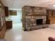 Inviting living room featuring a stone fireplace and wood-paneled walls at 370 Rosetta Nw Ln, Conyers, GA 30012
