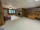 Spacious living room with a stone fireplace, carpet, and built-in wooden shelves at 370 Rosetta Nw Ln, Conyers, GA 30012