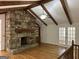 Living room showcases a vaulted ceiling with beams, stone fireplace, and built-in bookcase at 370 Rosetta Nw Ln, Conyers, GA 30012