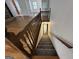 Carpeted stairway with wood banister leading to the lower level at 370 Rosetta Nw Ln, Conyers, GA 30012