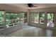 Bright sunroom featuring tiled floors and large windows overlooking a wooded area at 370 Rosetta Nw Ln, Conyers, GA 30012