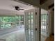 Bright sunroom featuring tiled floors and large windows overlooking a wooded area at 370 Rosetta Nw Ln, Conyers, GA 30012