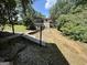 Sloped back yard with stone stairs leading to house with white porch at 370 Rosetta Nw Ln, Conyers, GA 30012
