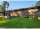 Exterior of a brick house with a grassy backyard and mature trees at 4157 Cedar Valley Ln, Conley, GA 30288