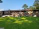 Large backyard with a brick house and a well-maintained lawn at 4157 Cedar Valley Ln, Conley, GA 30288
