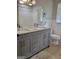 Bathroom featuring double sink vanity, tiled floors, and natural lighting from the window at 4157 Cedar Valley Ln, Conley, GA 30288