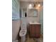 Bathroom featuring a toilet, vanity, shower and window with blinds at 4157 Cedar Valley Ln, Conley, GA 30288