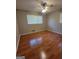 Neutral bedroom featuring wood-look floors, ceiling fan and a window with blinds at 4157 Cedar Valley Ln, Conley, GA 30288