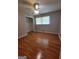 Bedroom featuring hardwood floors, a ceiling fan, and natural light from the window at 4157 Cedar Valley Ln, Conley, GA 30288