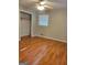 Neutral bedroom featuring wood-look floors, ceiling fan, a closet and a window with blinds at 4157 Cedar Valley Ln, Conley, GA 30288
