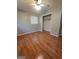 Neutral bedroom featuring wood-look floors, ceiling fan, a closet and a window with blinds at 4157 Cedar Valley Ln, Conley, GA 30288