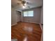Neutral bedroom featuring wood-look floors, ceiling fan, a closet and a window with blinds at 4157 Cedar Valley Ln, Conley, GA 30288