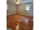 Neutral bedroom featuring wood-look floors, ceiling fan and a window with blinds at 4157 Cedar Valley Ln, Conley, GA 30288